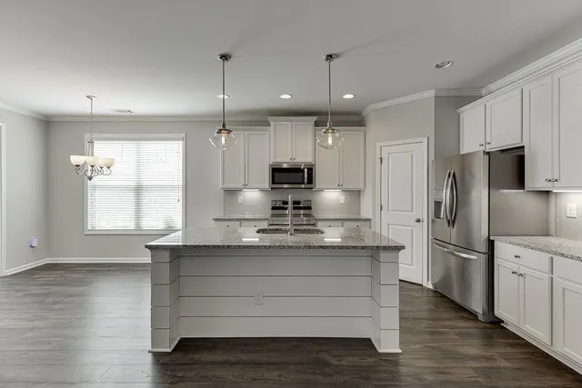 a kitchen with kitchen island white cabinets appliances and center island