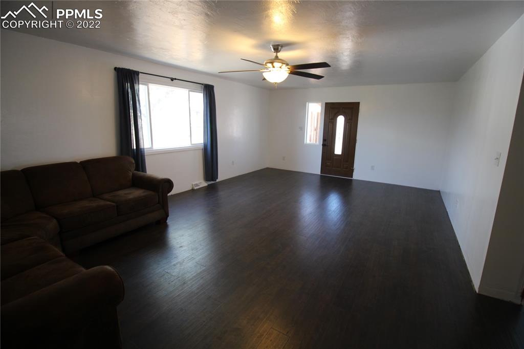 1526 Noe Road Larkspur, CO 80118 - Photo 11 of 29 a living room with furniture and a chandelier