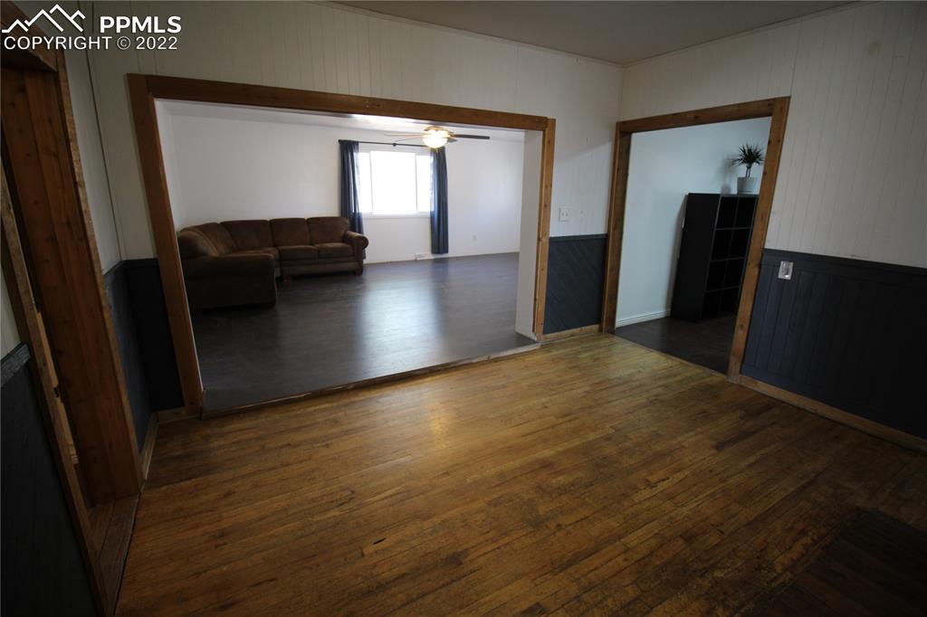 1526 Noe Road Larkspur, CO 80118 - Photo 13 of 29 a view of a hallway with wooden floor and stairs