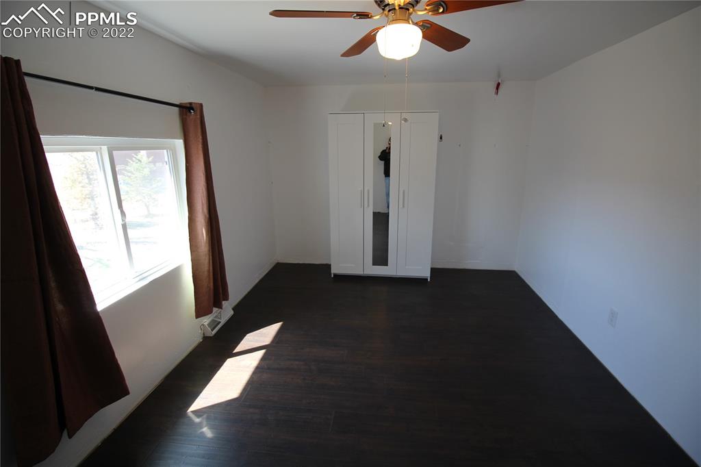 1526 Noe Road Larkspur, CO 80118 - Photo 14 of 29 wooden floor in an empty room with a window