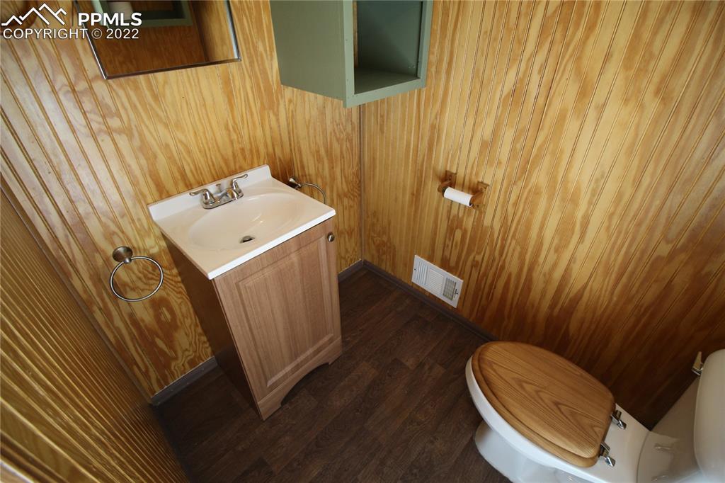 1526 Noe Road Larkspur, CO 80118 - Photo 25 of 29 a bathroom with a sink a toilet and shower curtain