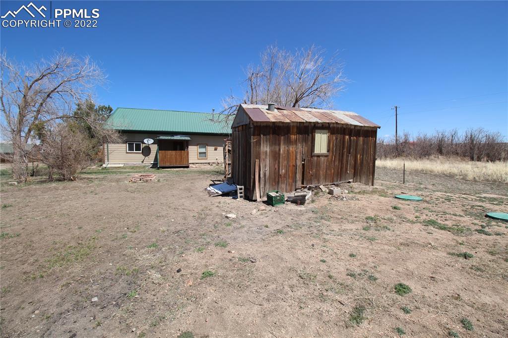 1526 Noe Road Larkspur, CO 80118 - Photo 27 of 29 a view of a house with a yard