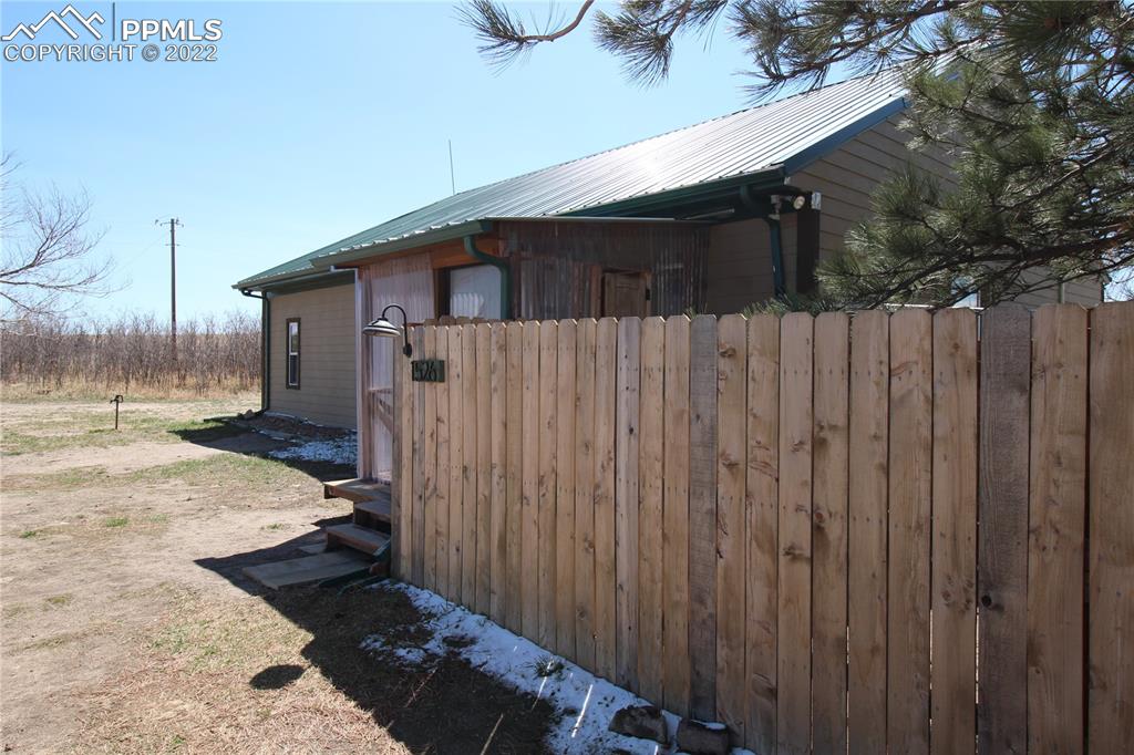 1526 Noe Road Larkspur, CO 80118 - Photo 5 of 29 a view of a house with a wooden fence