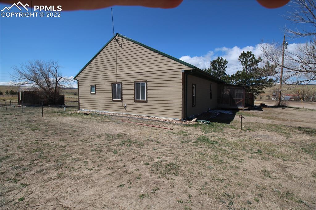1526 Noe Road Larkspur, CO 80118 - Photo 6 of 29 a view of a house with a yard