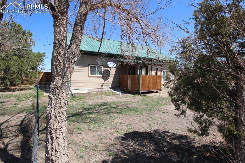 1526 Noe Road Larkspur, CO 80118 - Photo 8 of 29 a view of a house with backyard and trees