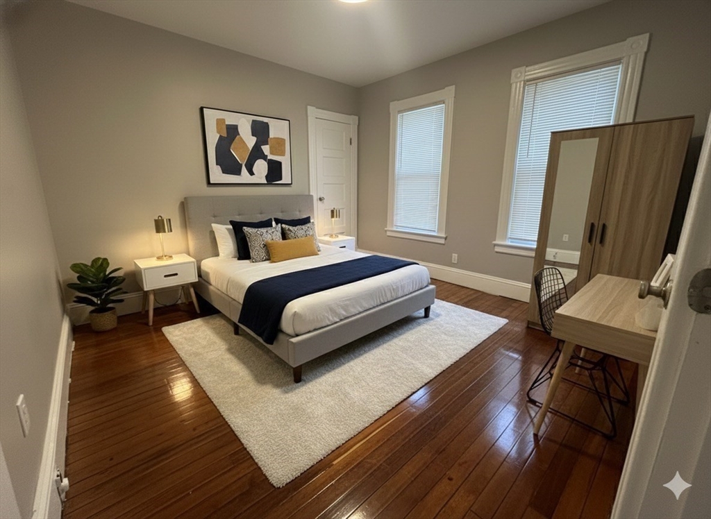 37 Cortland Street, Unit 1 Springfield, MA 01109 - Photo 11 of 14 a spacious bedroom with a bed a couch and a window