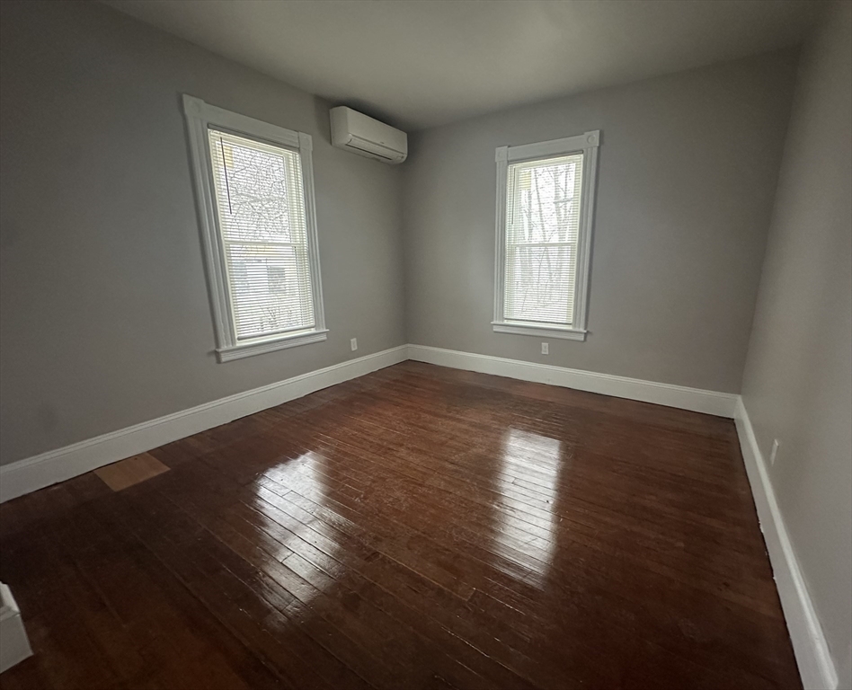 37 Cortland Street, Unit 1 Springfield, MA 01109 - Photo 12 of 14 an empty room with wooden floor and windows