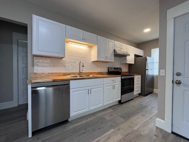 37 Cortland Street, Unit 1 Springfield, MA 01109 - Photo 2 of 14 a kitchen with stainless steel appliances kitchen island granite countertop a sink cabinets and wooden floor