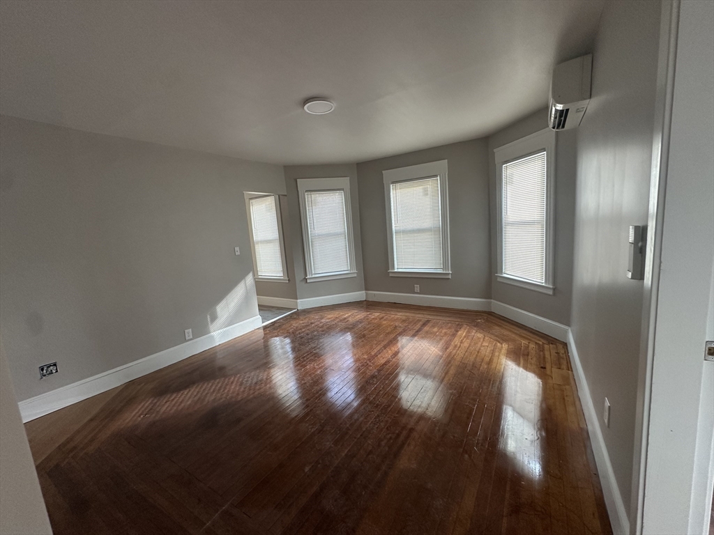37 Cortland Street, Unit 1 Springfield, MA 01109 - Photo 7 of 14 wooden floor in an empty room with a window