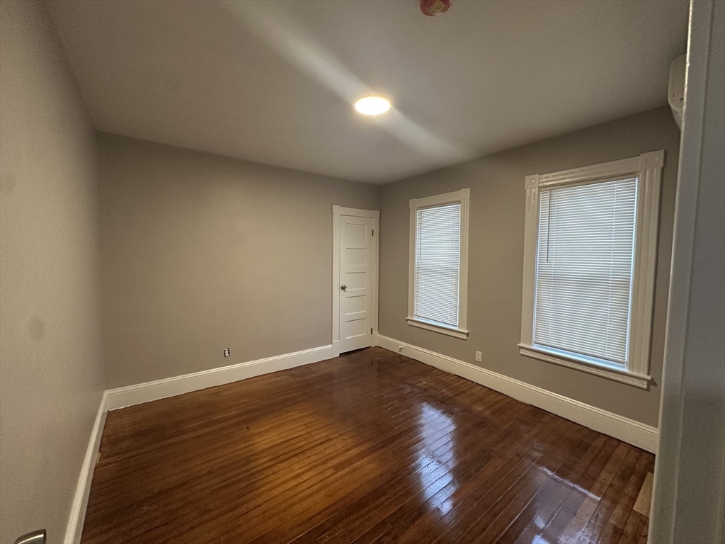 37 Cortland Street, Unit 1 Springfield, MA 01109 - Photo 10 of 14 an empty room with wooden floor and windows