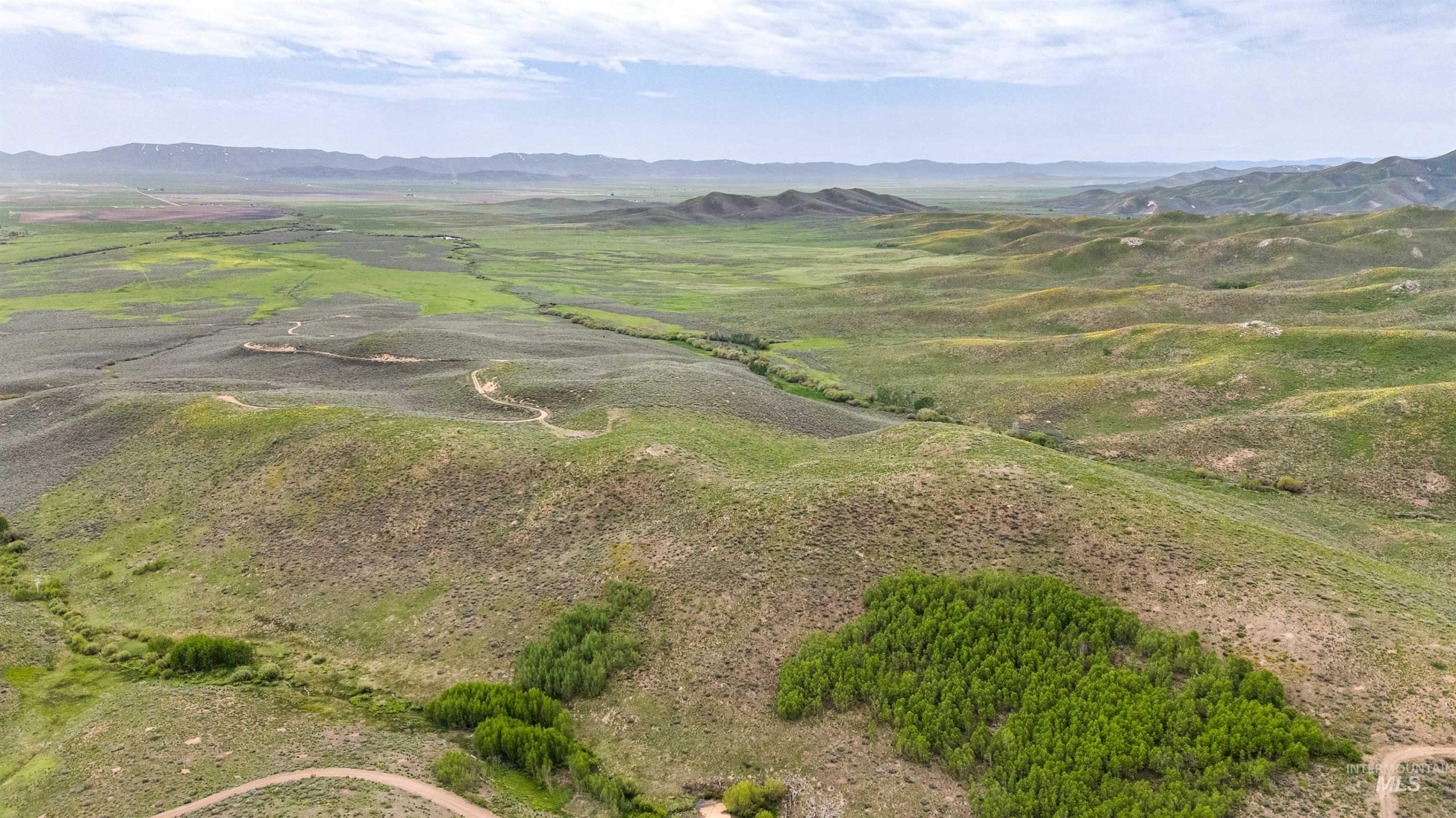 Tbd Homestead Road Fairfield, ID 83327 - Photo 11 of 15 Aerial view of property and surrounding area with a mountainous background