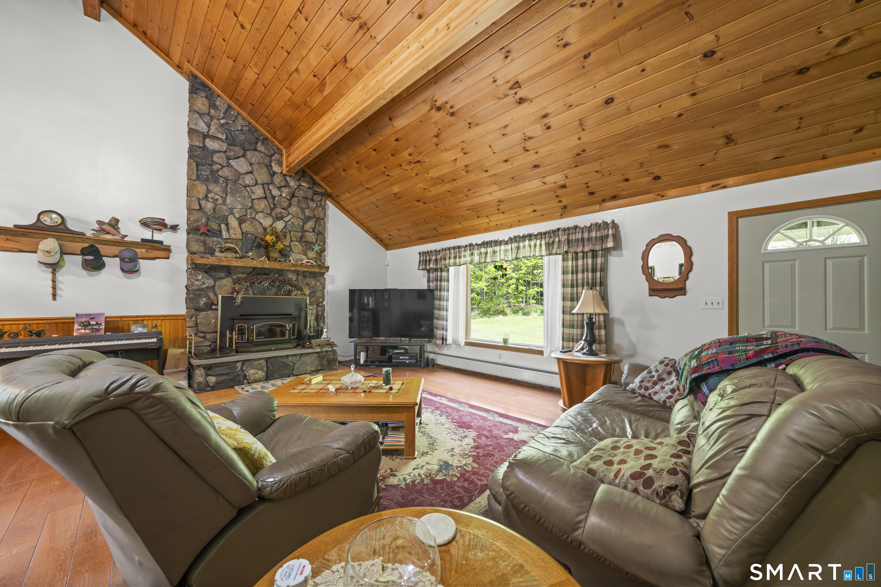 80 Holmes Road Goshen, CT 06756 - Photo 25 of 40 a living room with furniture a fireplace and a large window