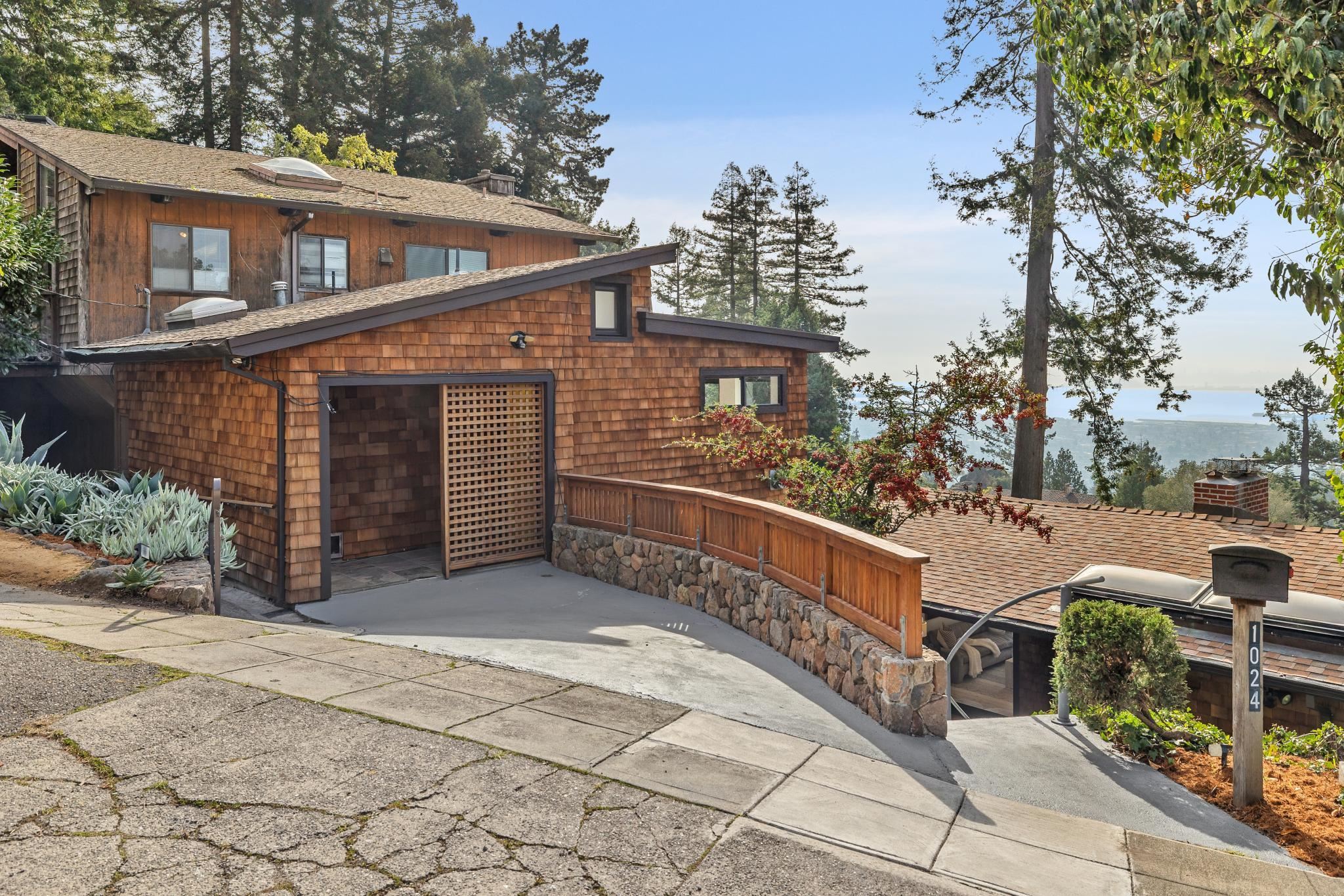 View of front facade featuring a chimney and roof with shingles