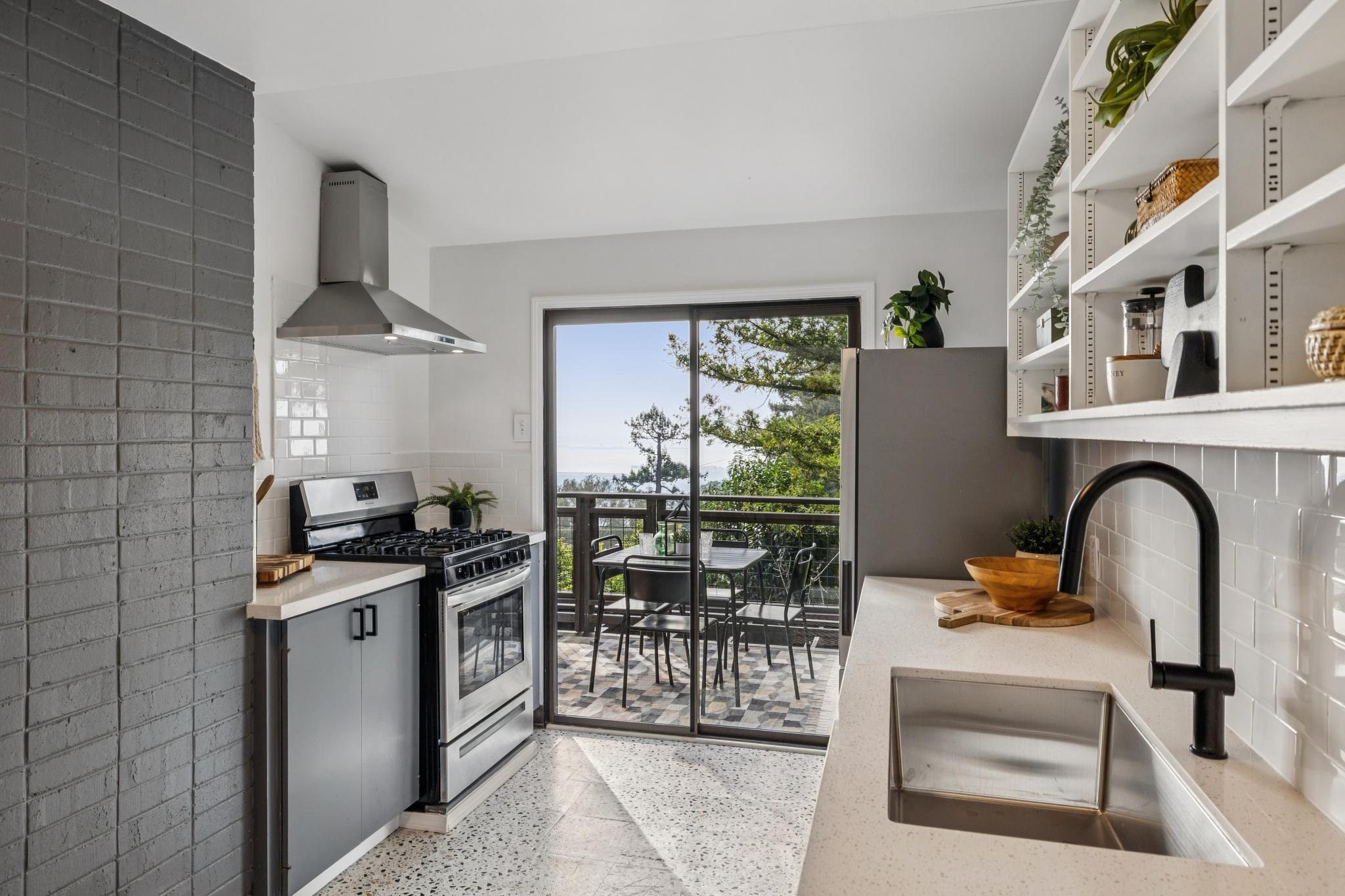 1024 Miller Avenue Berkeley, CA 94708 - Photo 20 of 60 Kitchen with dark aggregate flooring, appliances with stainless steel finishes, wall chimney range hood, and tasteful backsplash