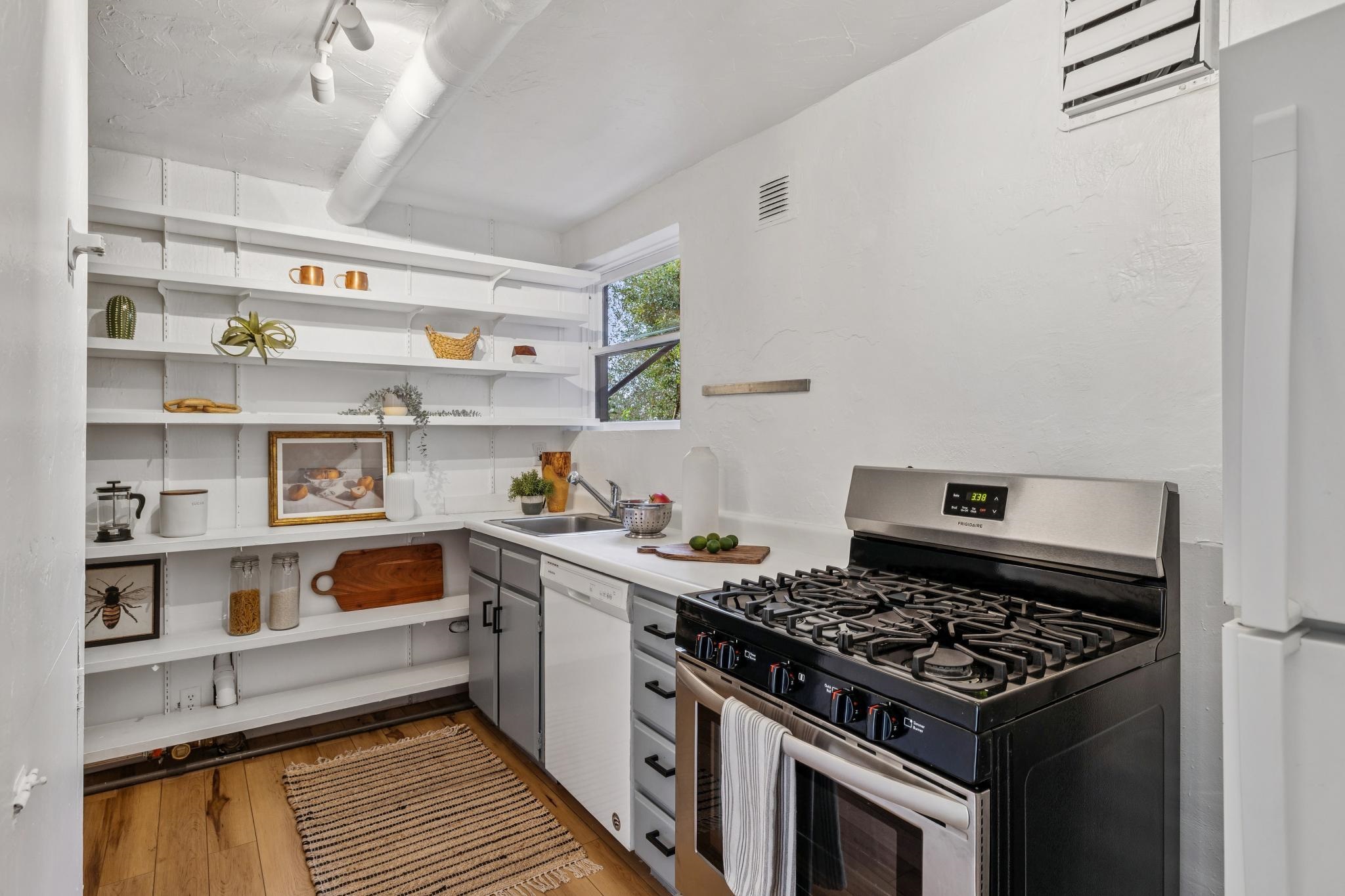 1024 Miller Avenue Berkeley, CA 94708 - Photo 38 of 60 Kitchen featuring white appliances, light countertops, light wood-style floors, and track lighting