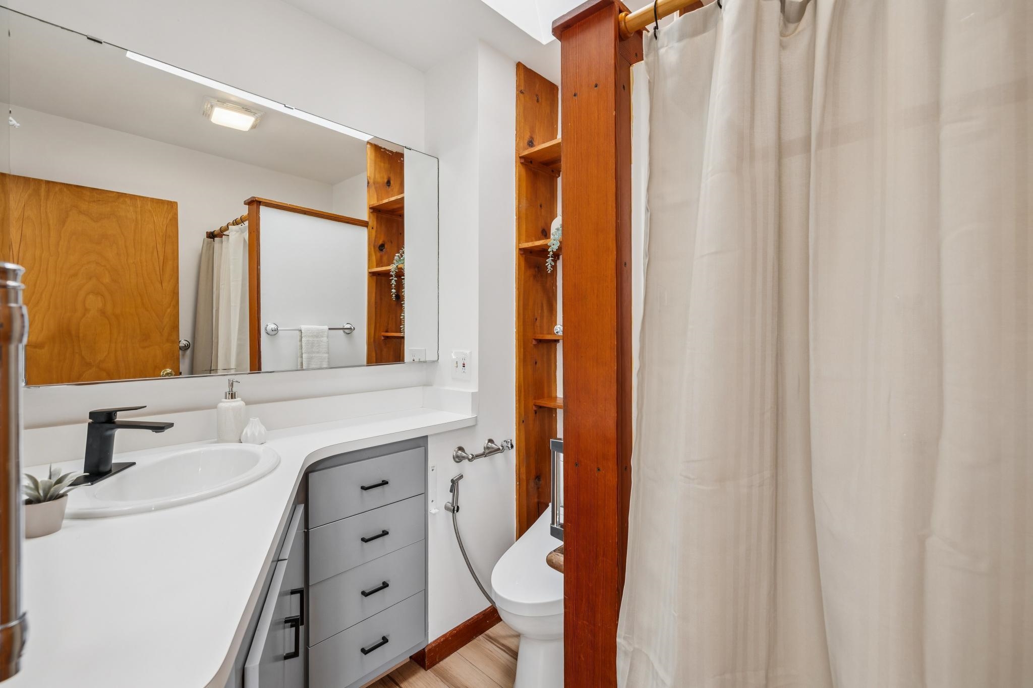 1024 Miller Avenue Berkeley, CA 94708 - Photo 57 of 60 Full bathroom featuring vanity, a shower with curtain, and light wood finished floors