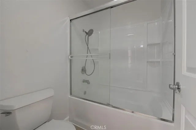 a bathroom with a shower and a toilet