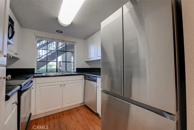 a kitchen with stainless steel appliances a refrigerator and a sink
