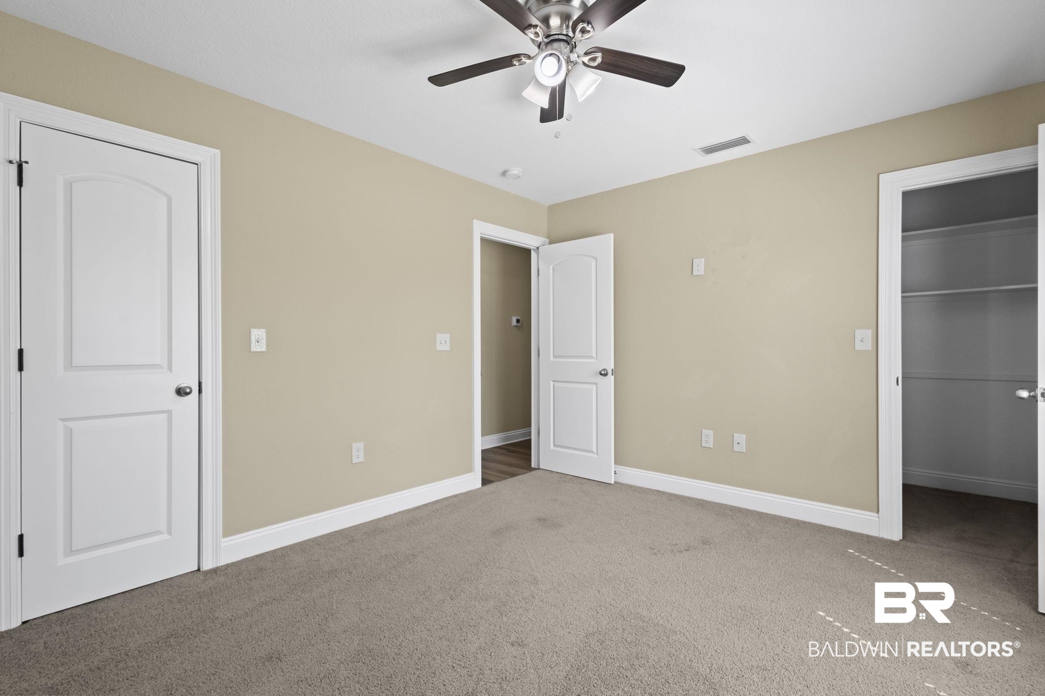 8781 Baptist Camp Road Elberta, AL 36530 - Photo 21 of 44 Unfurnished bedroom featuring a spacious closet, carpet flooring, visible vents, and baseboards