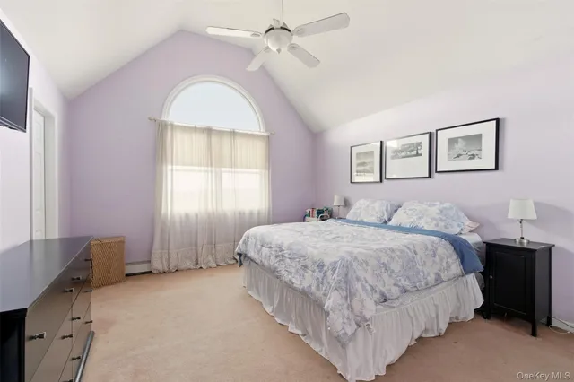 a spacious bedroom with a bed and a window