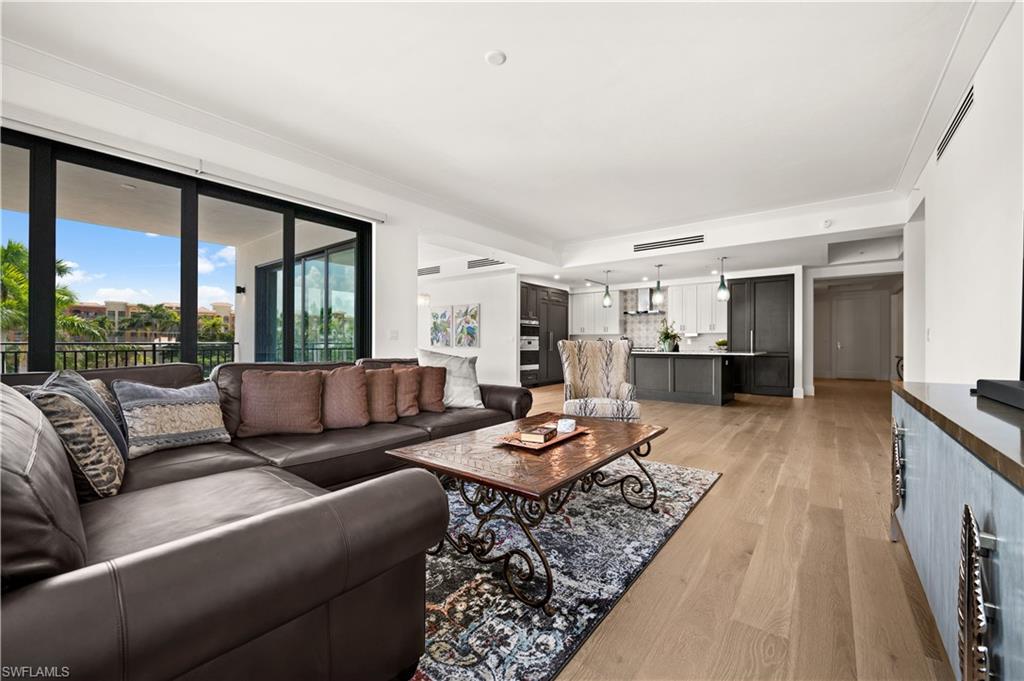 1130 3rd Avenue South, Unit 309 Naples, FL 34102 - Photo 11 of 29 a living room with furniture and a large window