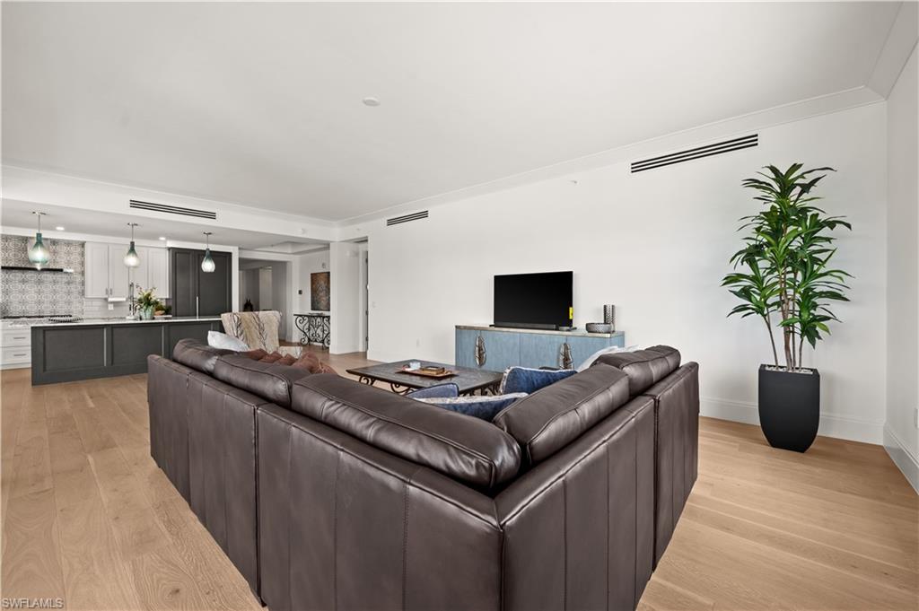1130 3rd Avenue South, Unit 309 Naples, FL 34102 - Photo 12 of 29 a living room with furniture and a flat screen tv