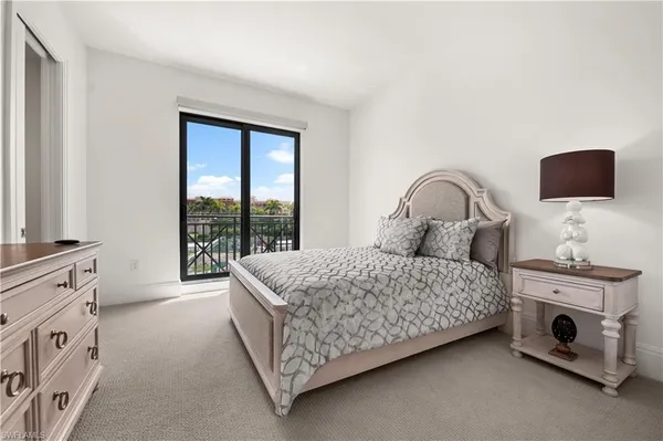 a bedroom with a bed chair and a window