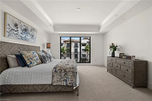 a living room with a large bed and a dresser