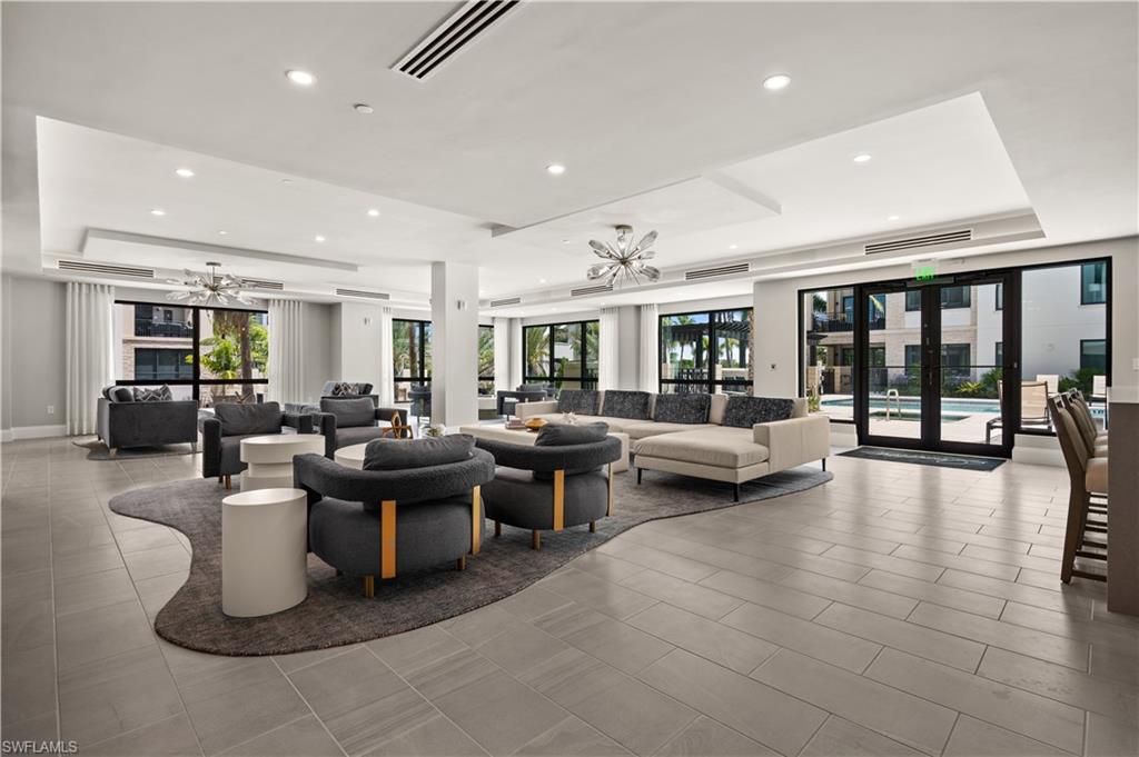 1130 3rd Avenue South, Unit 309 Naples, FL 34102 - Photo 19 of 29 a living room with furniture and a table