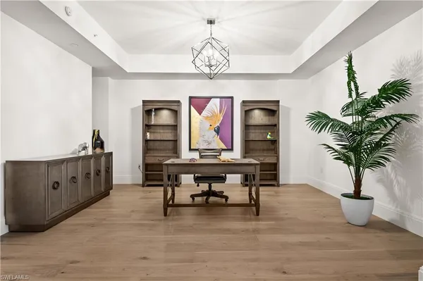 a view of a room with furniture wooden floor and windows