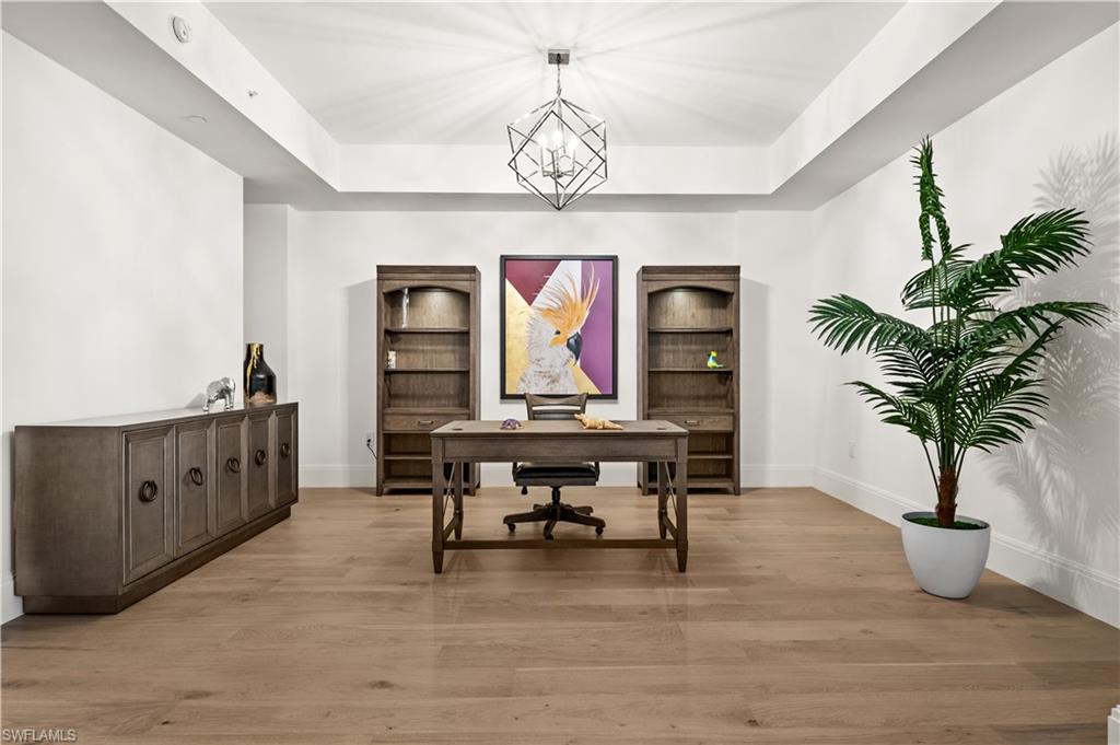1130 3rd Avenue South, Unit 309 Naples, FL 34102 - Photo 6 of 29 a view of a room with furniture wooden floor and windows