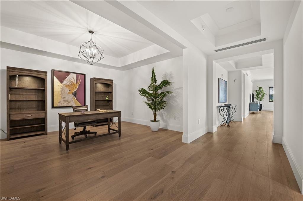 1130 3rd Avenue South, Unit 309 Naples, FL 34102 - Photo 7 of 29 a view of a livingroom with furniture and a chandelier