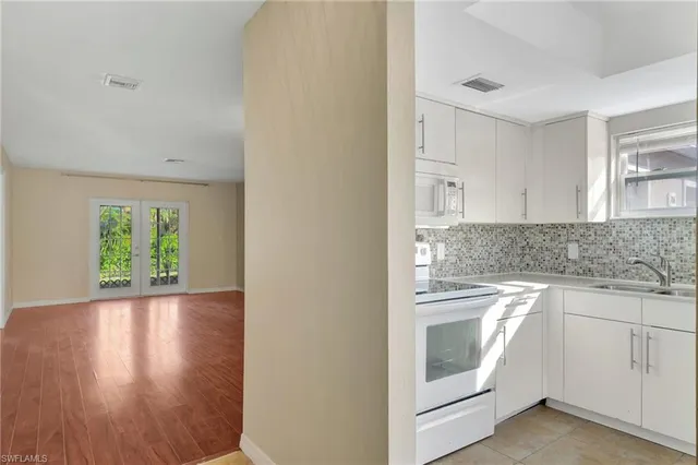 a kitchen with a stove top oven and sink