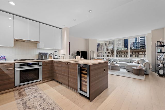 a kitchen with stainless steel appliances granite countertop a stove and a sink