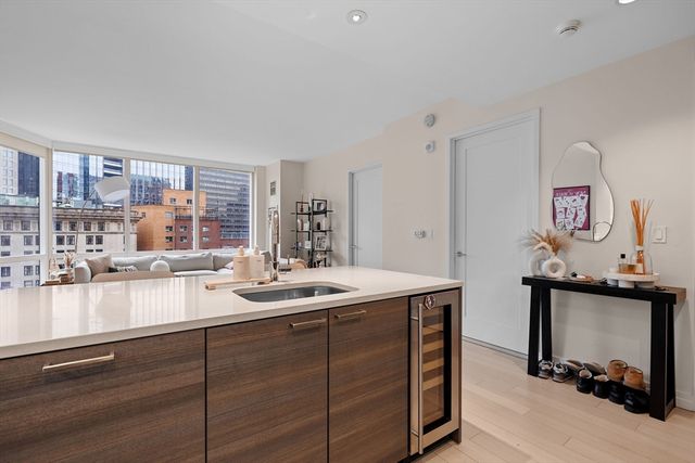 a kitchen with a sink cabinets and window