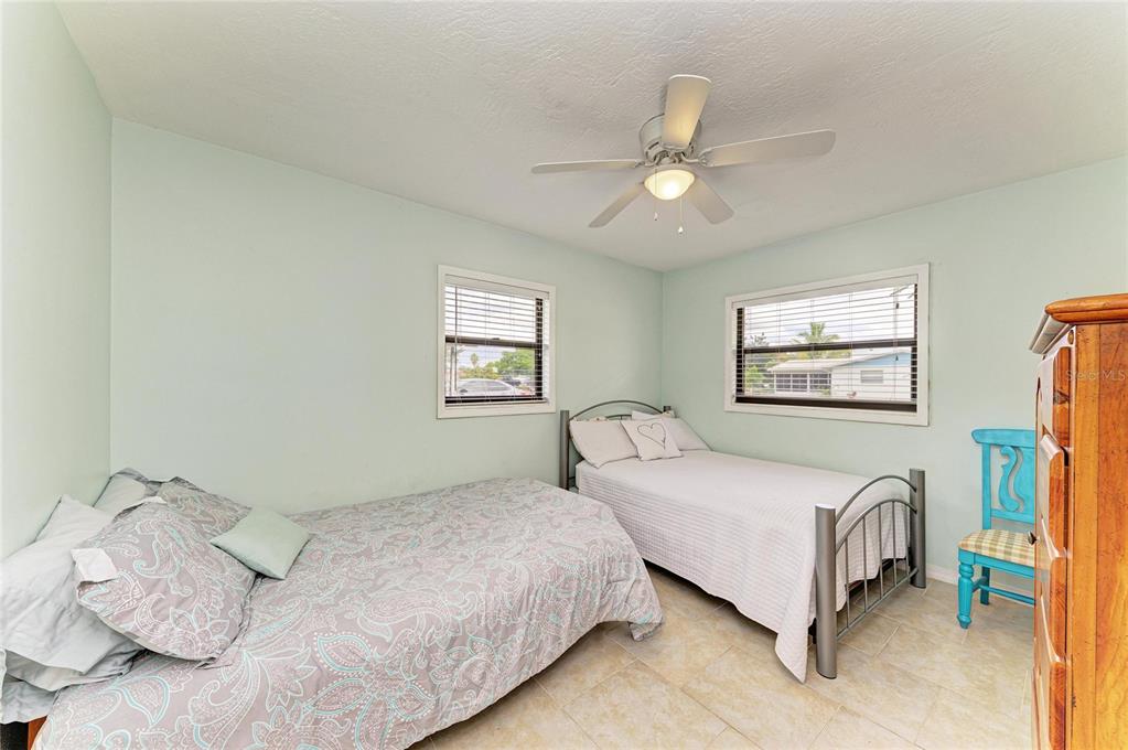 4424 87th St Court West Bradenton, FL 34210 - Photo 16 of 40 a bedroom with a bed and a chandelier