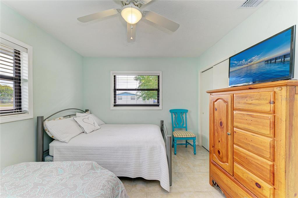 4424 87th St Court West Bradenton, FL 34210 - Photo 17 of 40 a bedroom with a bed and a chandelier