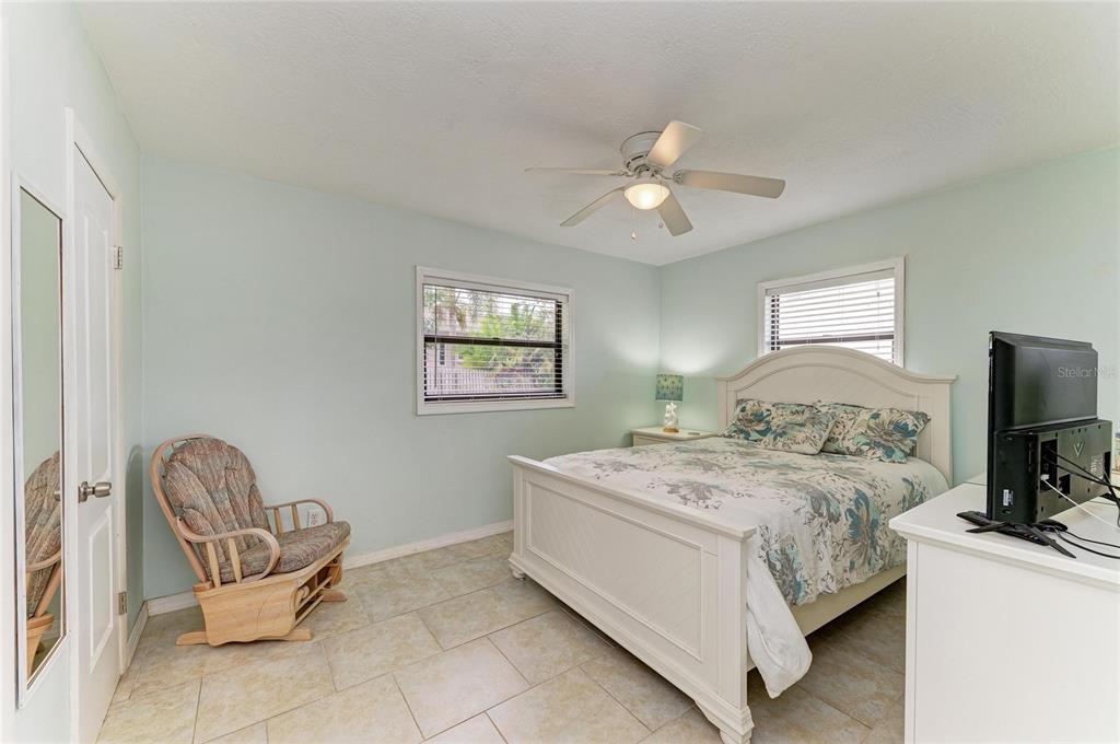 4424 87th St Court West Bradenton, FL 34210 - Photo 28 of 40 a bedroom with a bed and a flat screen tv