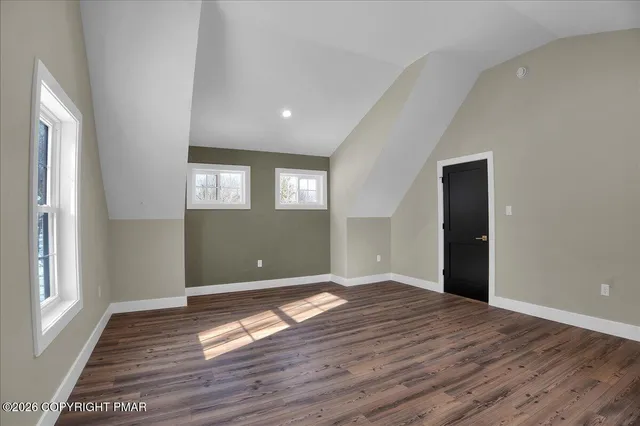 a spacious bedroom with a large bed and a dresser