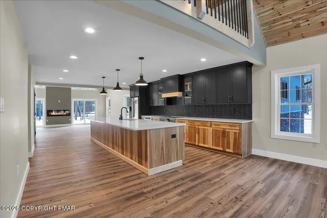 a kitchen with granite countertop a stove and a sink