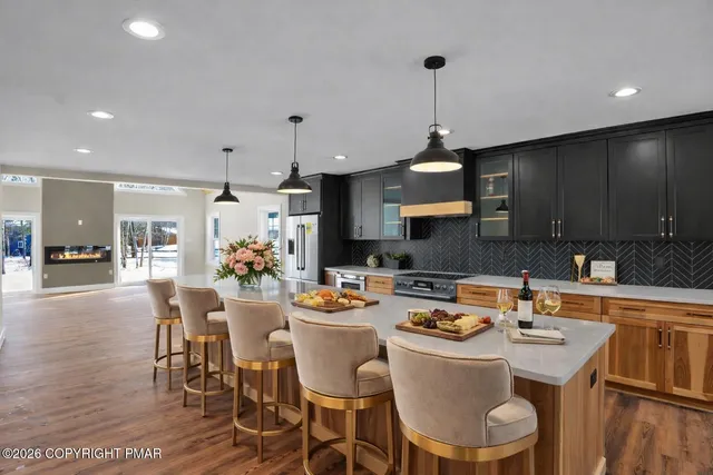 a kitchen with a dining table chairs and microwave