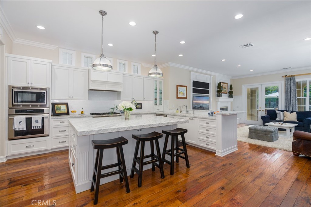 15 Seabluff Newport Beach, CA 92660 - Photo 2 of 2 a kitchen with stainless steel appliances granite countertop a kitchen island hardwood floor sink stove dining table and chairs