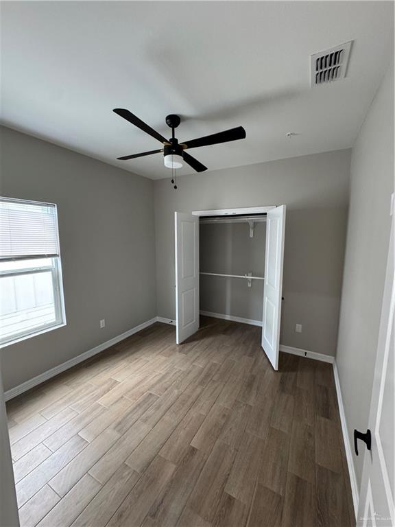 800 Ragland Road, Unit 10 Mission, TX 78572 - Photo 11 of 13 wooden floor in an empty room with a window