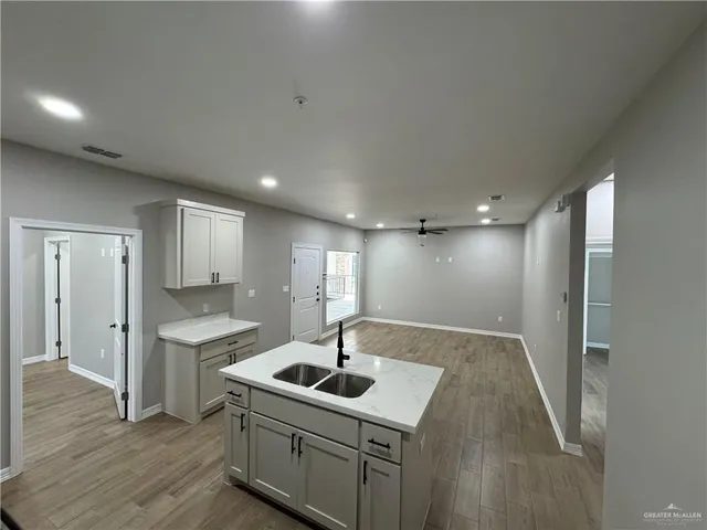 a view of a kitchen with a sink stainless steel appliances and cabinets