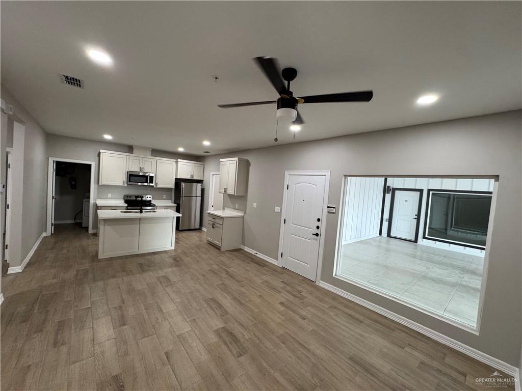 800 Ragland Road, Unit 10 Mission, TX 78572 - Photo 4 of 13 a view of a kitchen with a sink stainless steel appliances and cabinets
