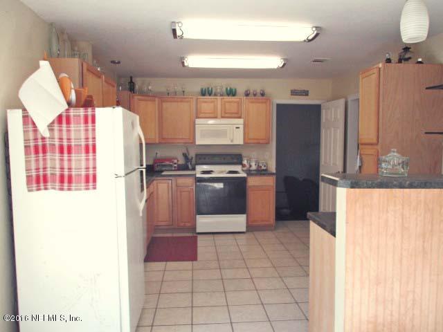 96726 Blackrock Road Yulee, FL 32097 - Photo 11 of 27 a kitchen with stainless steel appliances a refrigerator and a stove