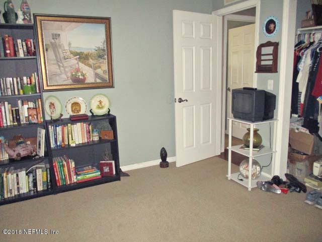 96726 Blackrock Road Yulee, FL 32097 - Photo 19 of 27 a view of a livingroom with shelves