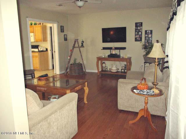 96726 Blackrock Road Yulee, FL 32097 - Photo 26 of 27 a living room with furniture and a flat screen tv