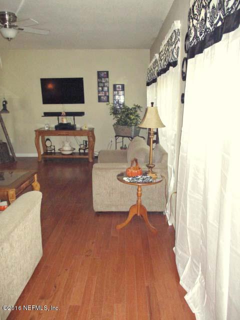 96726 Blackrock Road Yulee, FL 32097 - Photo 27 of 27 a living room with furniture and a flat screen tv