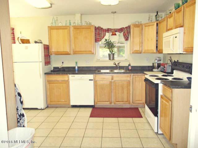96726 Blackrock Road Yulee, FL 32097 - Photo 3 of 27 a kitchen with a sink a stove a refrigerator and cabinets